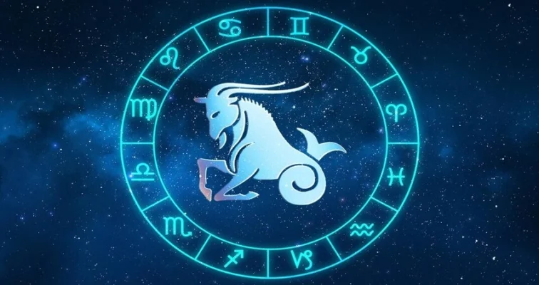 Glowing Capricorn zodiac sign, a horned goat-fish, within a circular astrological chart on a blue background.